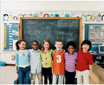 elementary school children in front of a blackboard