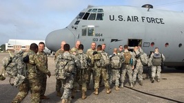 Members of the Connecticut National Guard board a cargo plane