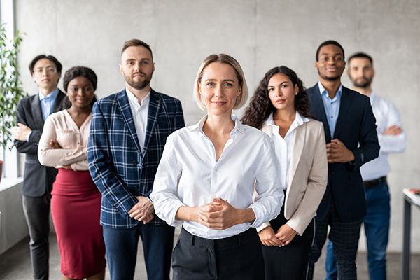A diverse team posing for a front-view group photo.