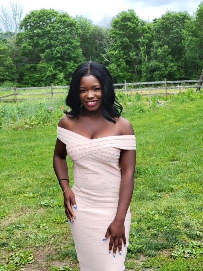 Betty standing outside in a beautiful white dress