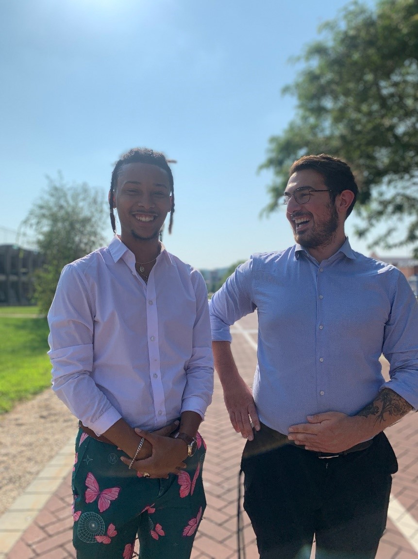 Photo of Sun Scholar participant Alan Abutin with founder Chris Scott.  Both are smiling brightly.