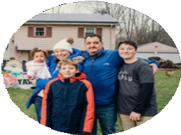 Photo of the Baxter family, including baby Amari, in front of their house in winter gear