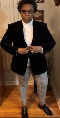 Image of Dr. Aissa Williams standing proudly in a black blazer 