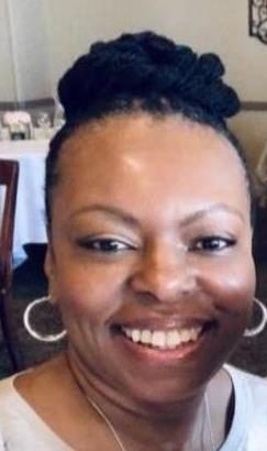 Image of DCF Nurse Melody Davis, BSN RN smiling cheerfully with cute hoop earrings 