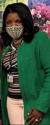 Photo of Commissioner Dorantes in a mask and green coat