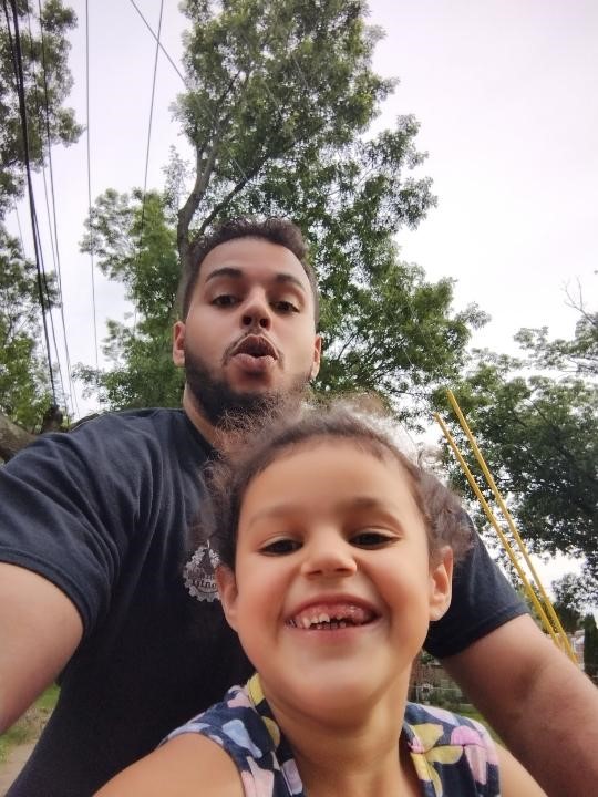 Joseph taking a photo with his daughter