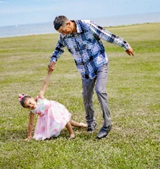 Olger and Aynara in the park from the same photoshoot.  They hold hands, and Aynara is falling over, with her other hand on the ground.