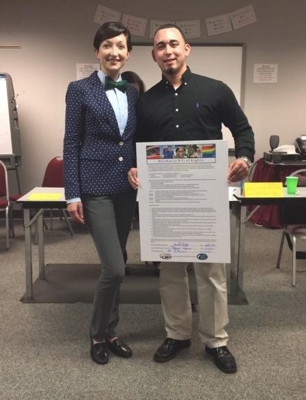 Vince standing with a signed copy of the Sibling Bill of Rights