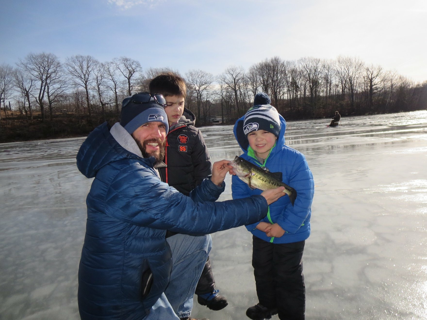 Anglers ice fishing on Coventry Lake showing off their catch.